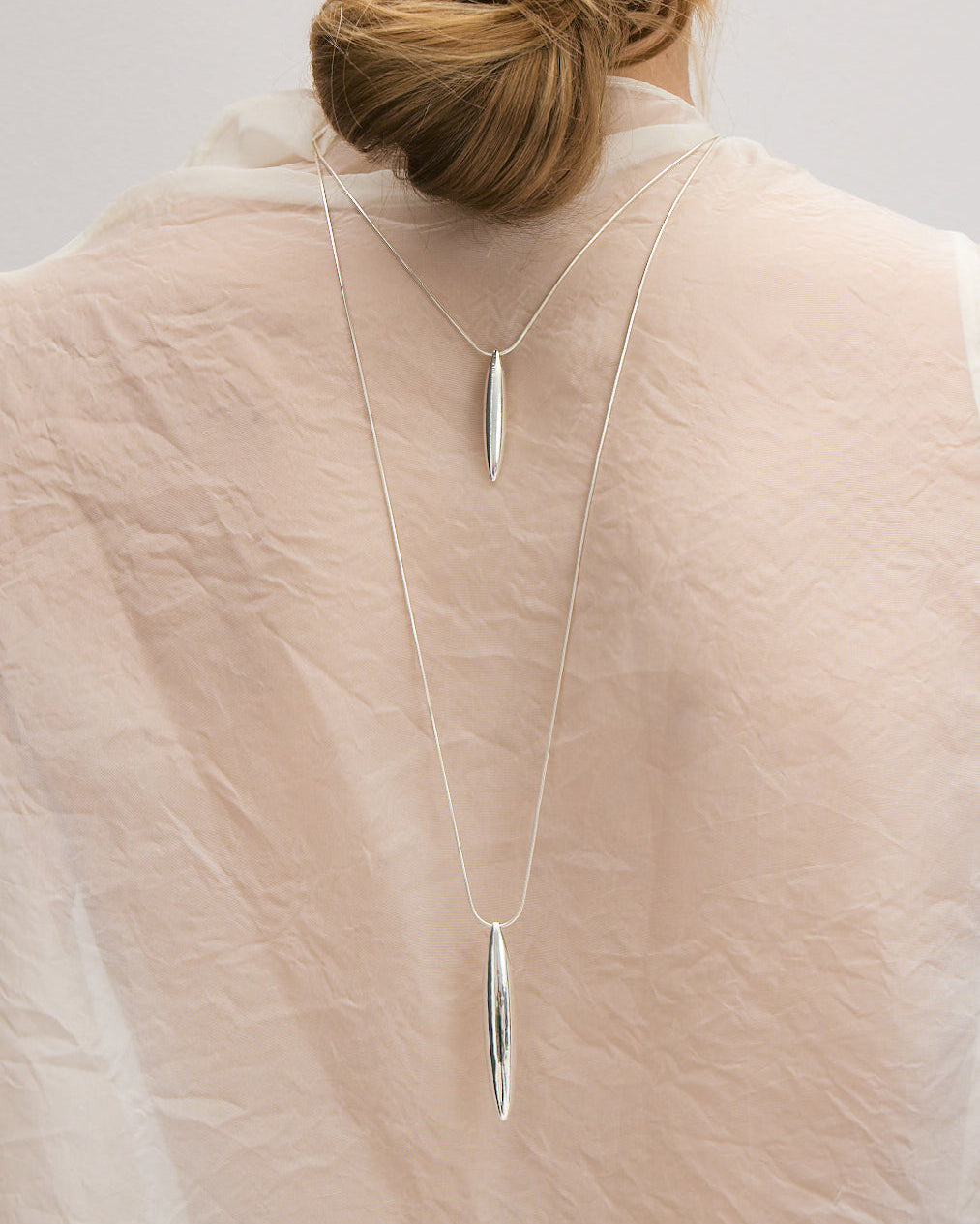 Ina large necklace